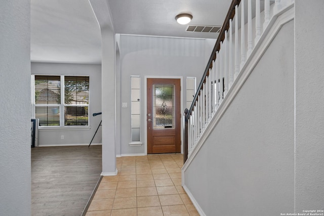 14519 Redwood Vly, San Antonio, TX 78023 - foyer entrance with stairway, baseboards, visible vents, and light wood-style floors