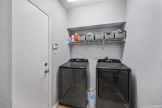 clothes washing area with separate washer and dryer