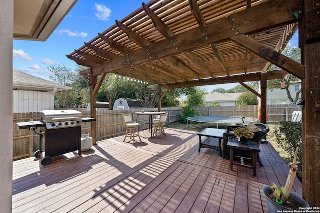 wooden deck with a pergola and area for grilling