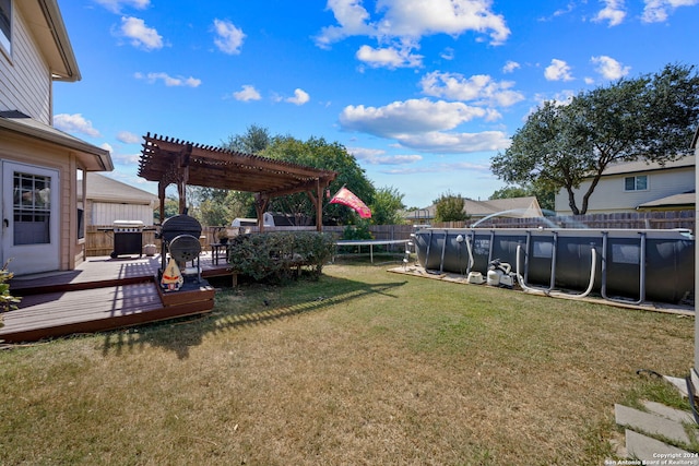 view of yard with a pergola and a pool side deck