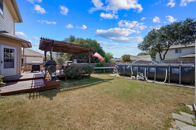 14519 Redwood Vly, San Antonio, TX 78023 - view of yard with an outdoor pool, a trampoline, a pergola, a deck, and a fenced backyard
