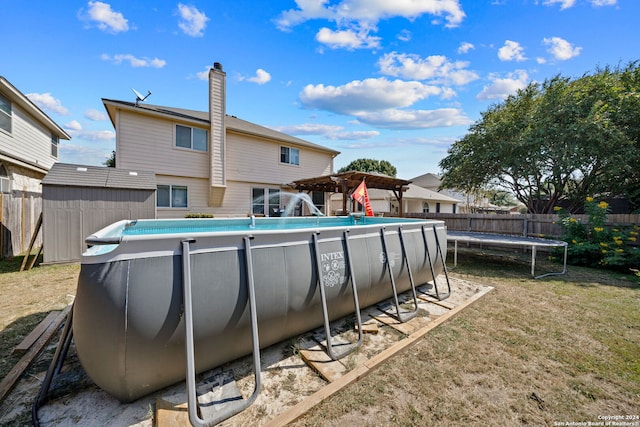 14519 Redwood Vly, San Antonio, TX 78023 - view of pool with fence, a trampoline, a storage shed, a fenced in pool, and a lawn