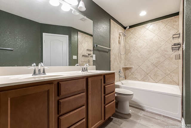 full bathroom with vanity, toilet, tiled shower / bath combo, and hardwood / wood-style floors