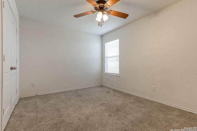 spare room with carpet flooring and ceiling fan