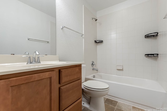 full bathroom featuring toilet, tiled shower / bath, vanity, and tile patterned floors