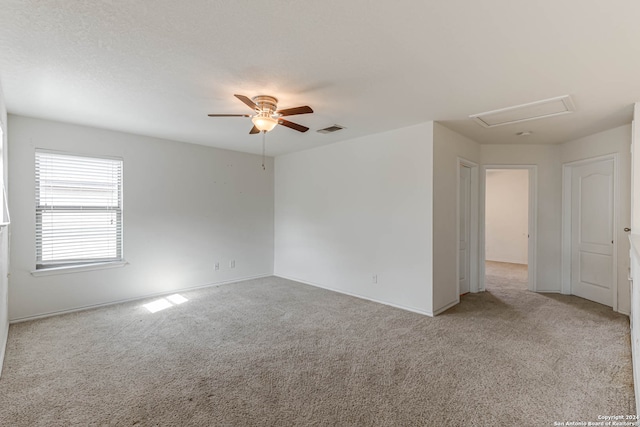 spare room with light colored carpet and ceiling fan