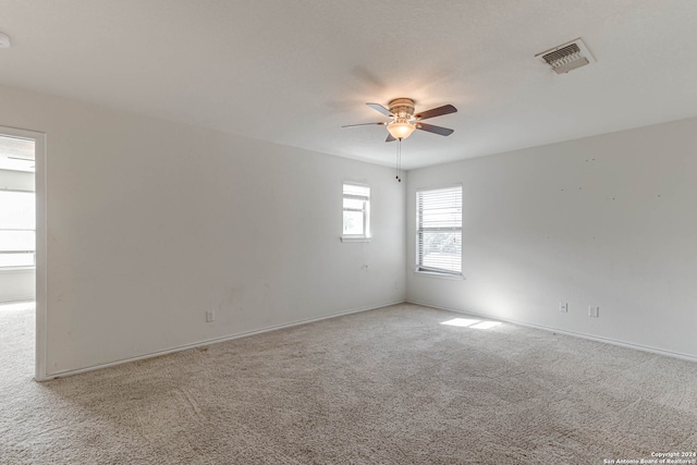 unfurnished room with ceiling fan and light colored carpet