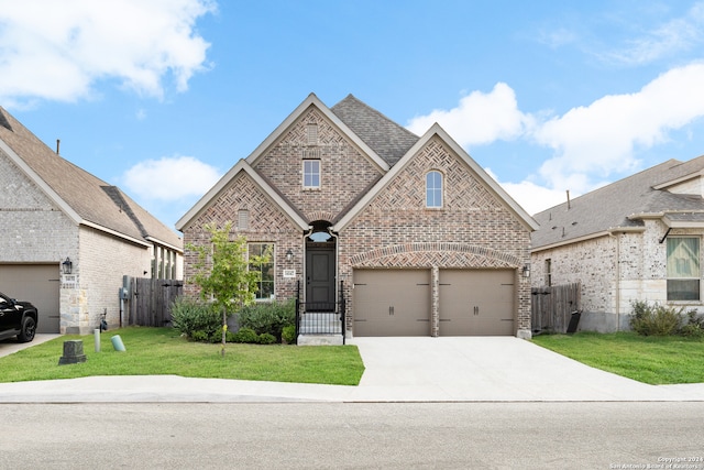 view of front of property featuring a front yard and a garage