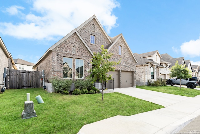 view of front of home featuring a front yard and a garage