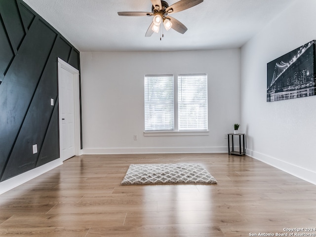 unfurnished room featuring ceiling fan and light wood-type flooring