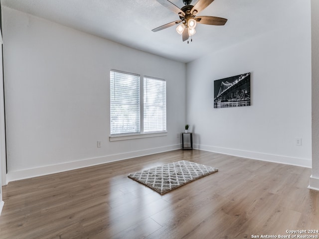 spare room with hardwood / wood-style floors and ceiling fan