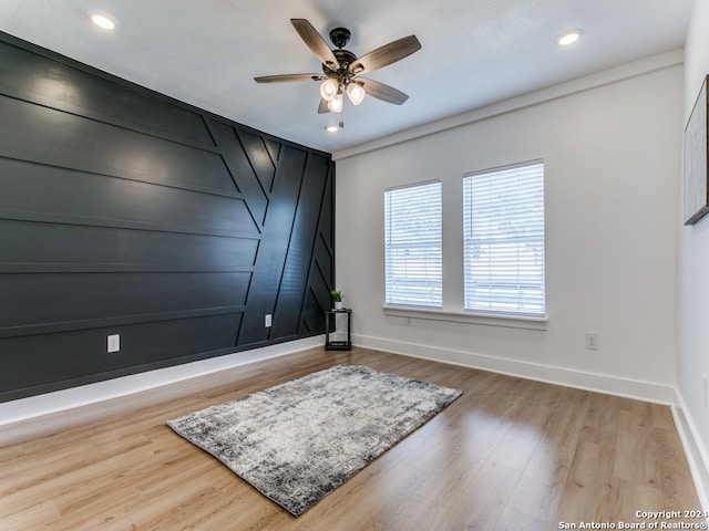 interior space with hardwood / wood-style floors and ceiling fan