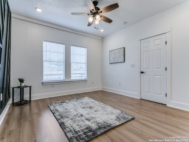 interior space with hardwood / wood-style floors and ceiling fan