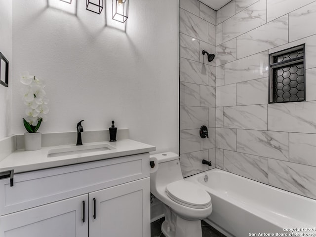 full bathroom featuring vanity, toilet, and tiled shower / bath combo