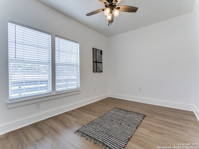 empty room featuring ceiling fan and light hardwood / wood-style flooring