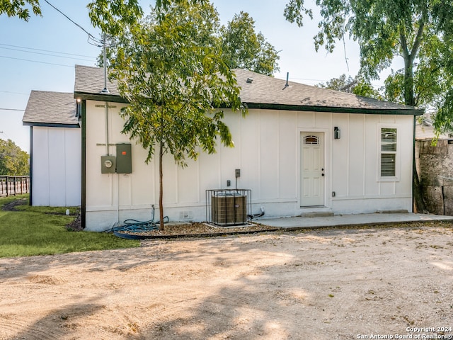 rear view of property featuring central AC