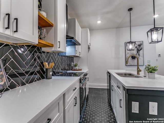 kitchen featuring sink, decorative light fixtures, white cabinetry, appliances with stainless steel finishes, and tasteful backsplash