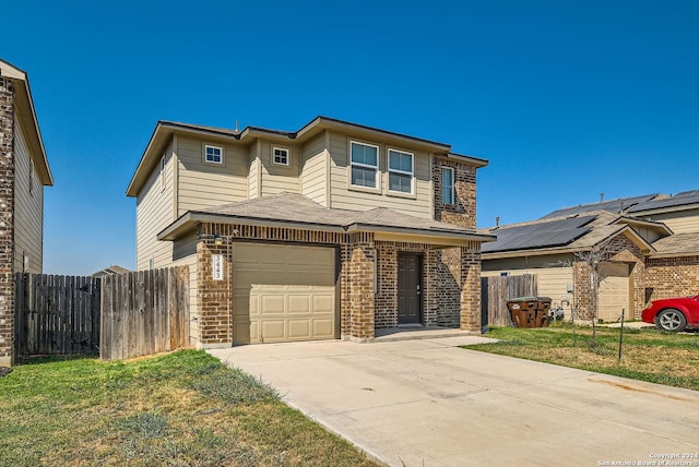traditional-style house with a garage, brick siding, fence, and concrete driveway