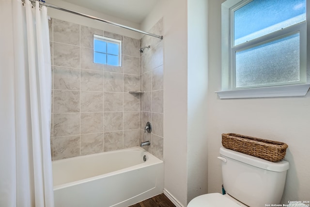 bathroom featuring hardwood / wood-style floors, shower / tub combo, and toilet