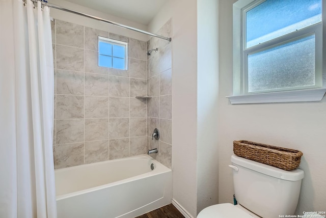 bathroom featuring toilet and shower / tub combo