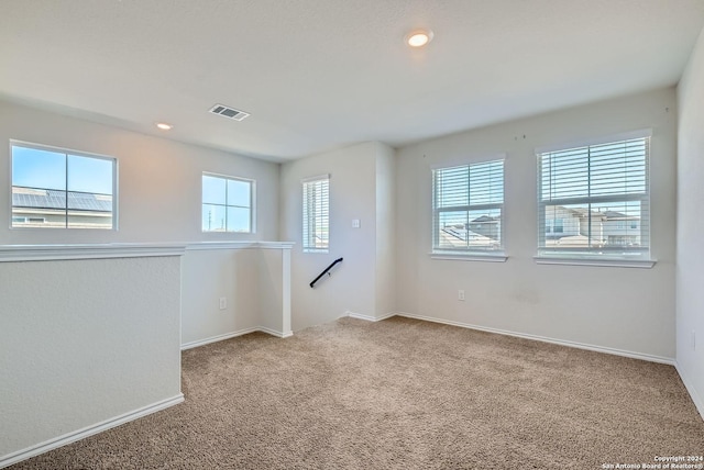 carpeted spare room with recessed lighting, visible vents, and baseboards