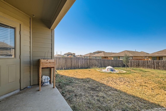 view of yard with a patio and a fenced backyard