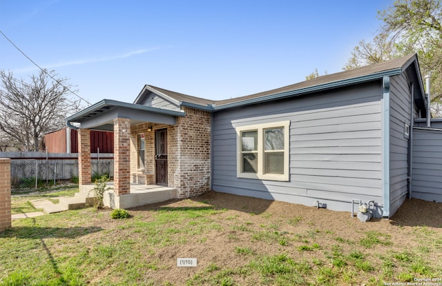 1627 Montezuma St, San Antonio, TX 78207 - view of front of property with fence and brick siding