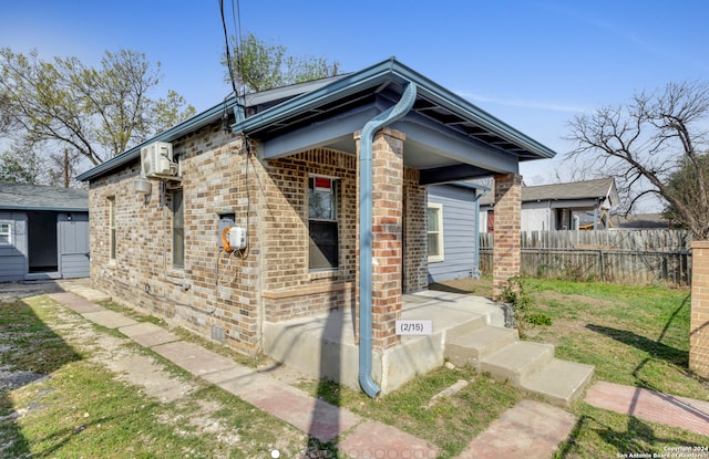 1627 Montezuma St, San Antonio, TX 78207 - view of side of home with brick siding and fence