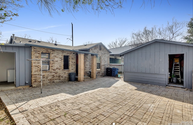 1627 Montezuma St, San Antonio, TX 78207 - back of house with a patio area, brick siding, and fence
