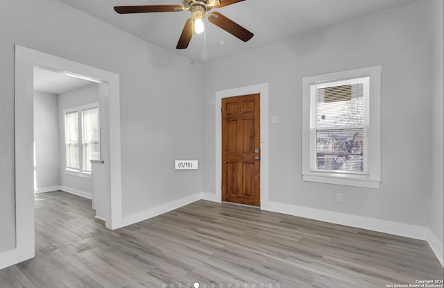 empty room with light wood-type flooring and ceiling fan