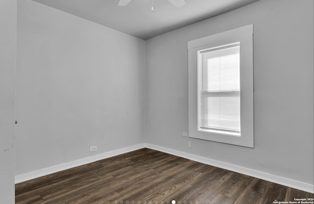 unfurnished room with ceiling fan and dark hardwood / wood-style flooring