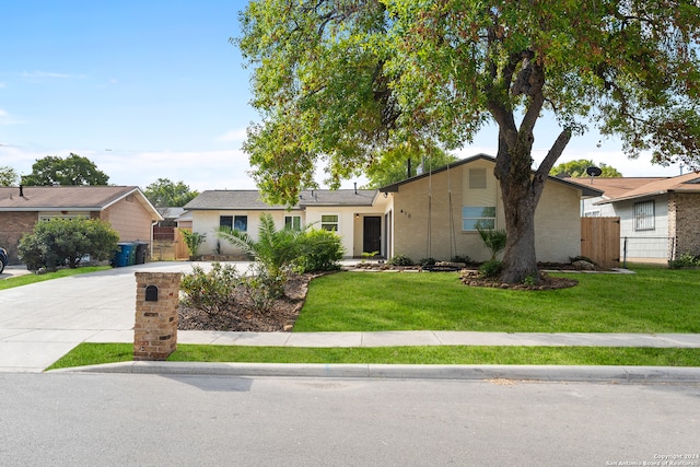 ranch-style home with a front lawn