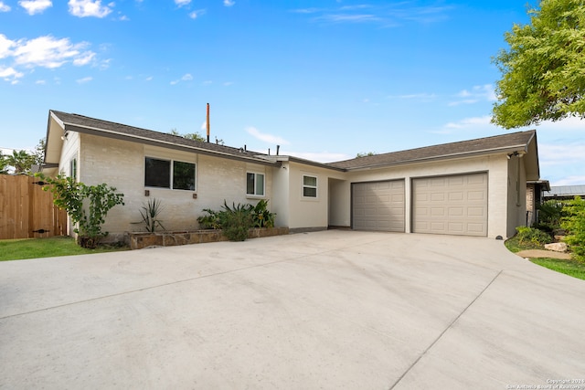 ranch-style home featuring a garage