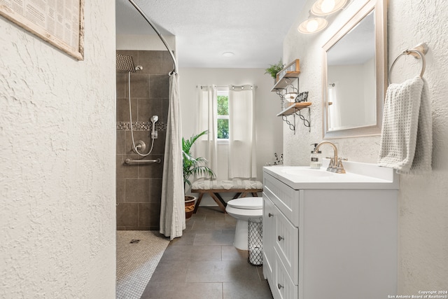 bathroom with vanity, toilet, a textured ceiling, and a shower with shower curtain