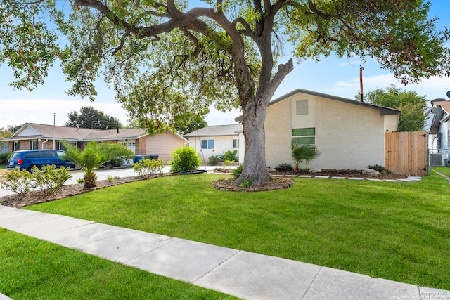 ranch-style home with a front lawn