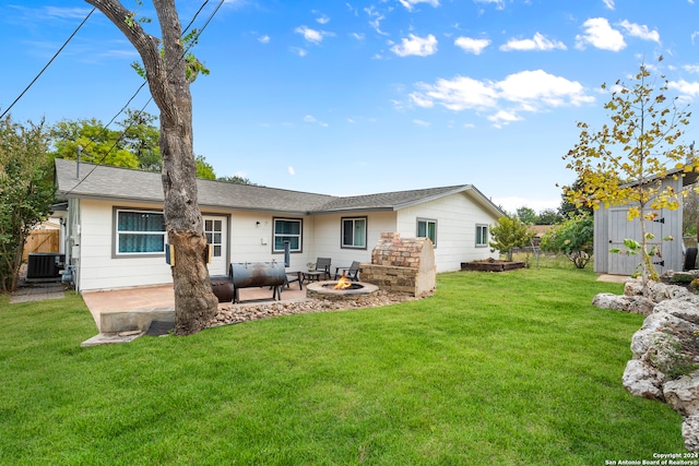 back of house featuring a patio area, a storage shed, central AC unit, and a lawn