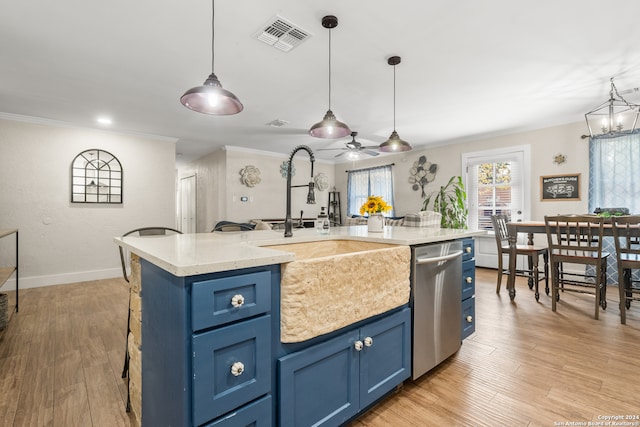 kitchen with dishwasher, a center island with sink, sink, decorative light fixtures, and blue cabinetry