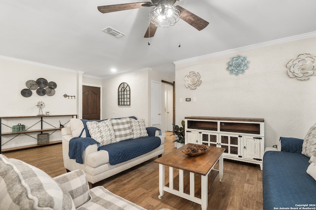 living room featuring dark wood-type flooring, crown molding, a barn door, and ceiling fan