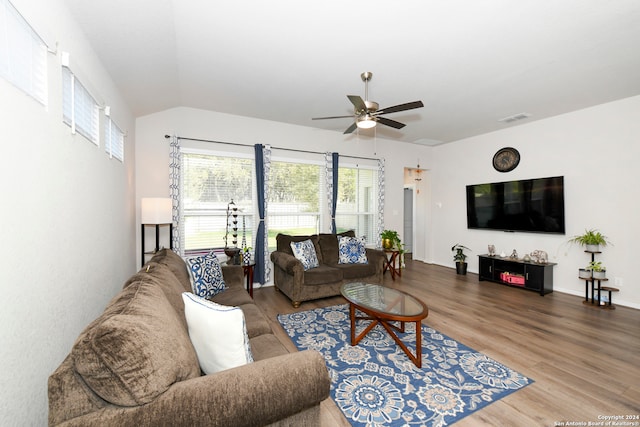 living room with ceiling fan, wood-type flooring, and lofted ceiling