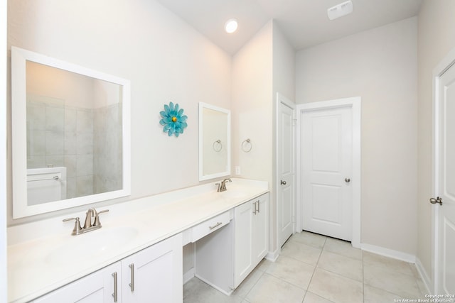 bathroom featuring vanity, tiled shower, and tile patterned flooring