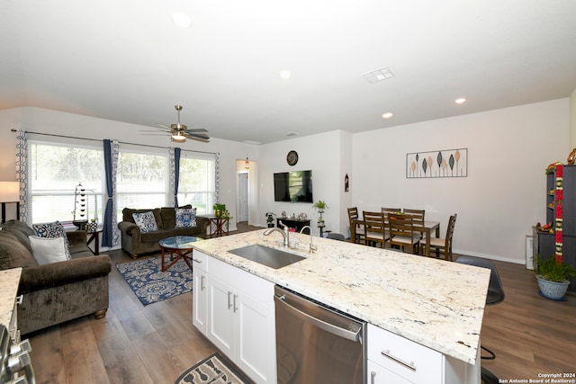 kitchen with dishwasher, sink, white cabinetry, hardwood / wood-style flooring, and a kitchen island with sink