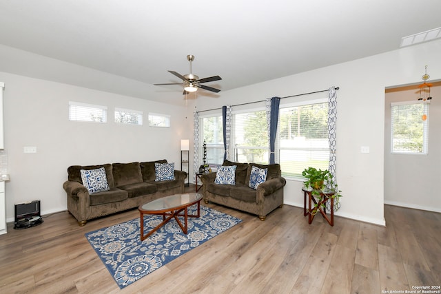 living room with light hardwood / wood-style flooring and ceiling fan