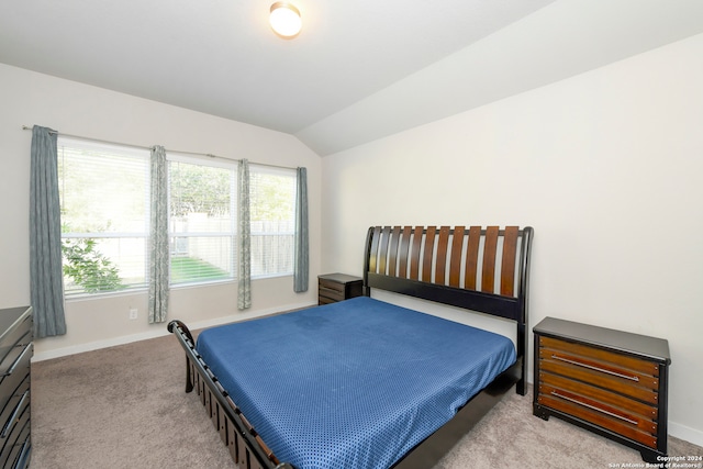 carpeted bedroom featuring lofted ceiling