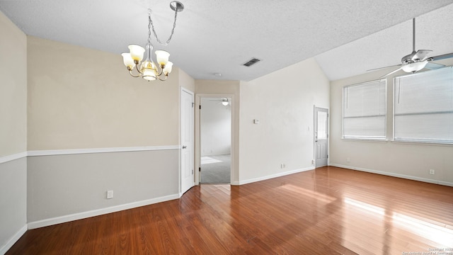 unfurnished room with a textured ceiling, lofted ceiling, ceiling fan with notable chandelier, and hardwood / wood-style flooring