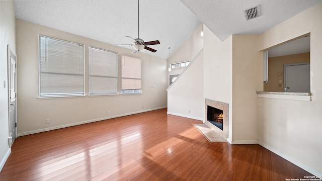 unfurnished living room featuring ceiling fan, a textured ceiling, and hardwood / wood-style flooring