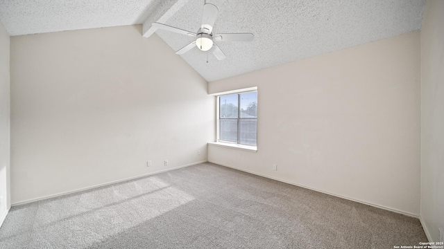 carpeted empty room with ceiling fan, a textured ceiling, and lofted ceiling with beams