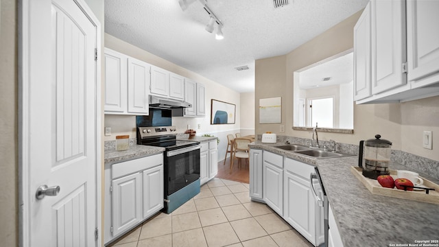 kitchen featuring stainless steel range with electric stovetop, white cabinetry, a textured ceiling, and sink