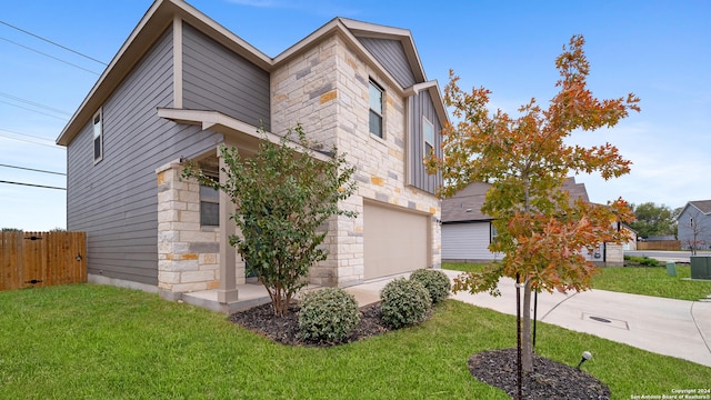 view of front of property featuring a garage and a front lawn