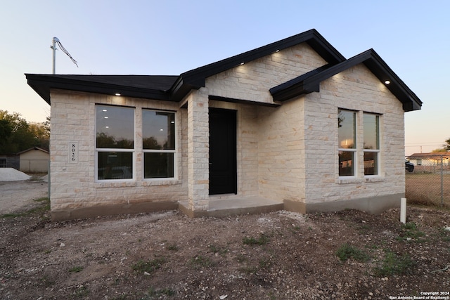 view of back house at dusk