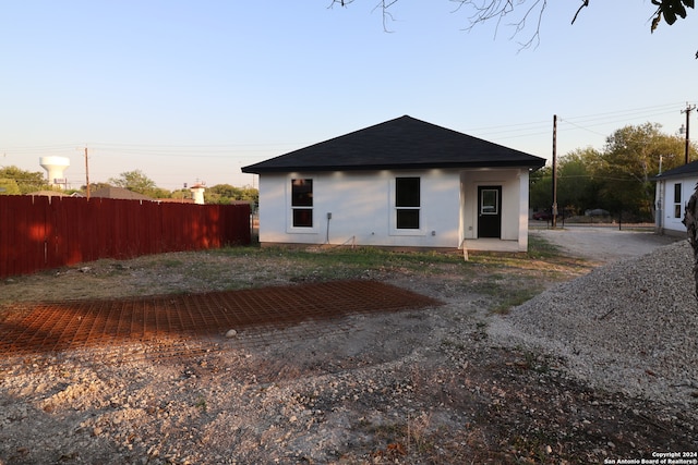 view of back house at dusk